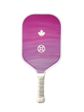 A pickleball paddle featuring a pink and purple gradient face with a white maple leaf and soccer ball logo, and a white wrapped handle, isolated on a white background.