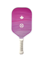 A pickleball paddle featuring a pink and purple gradient face with a white maple leaf and soccer ball logo, and a white wrapped handle, isolated on a white background.