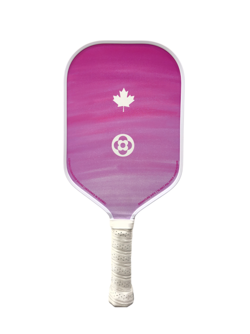 A pickleball paddle featuring a pink and purple gradient face with a white maple leaf and soccer ball logo, and a white wrapped handle, isolated on a white background.